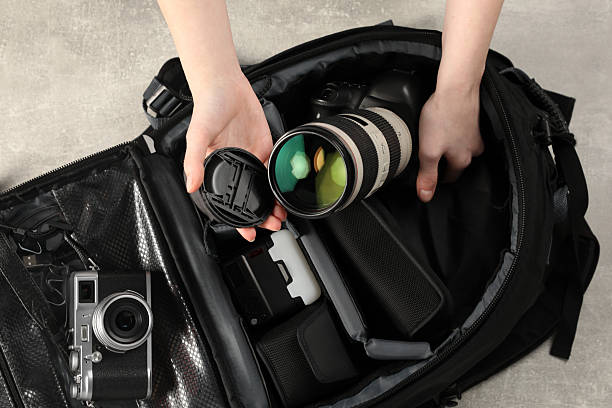 istock Photographer with professional equipment and backpack at light table, top view 2252058440