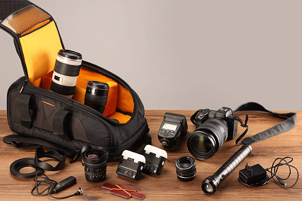 istock Professional photographer's equipment and backpack on wooden table. Space for text 2252058441