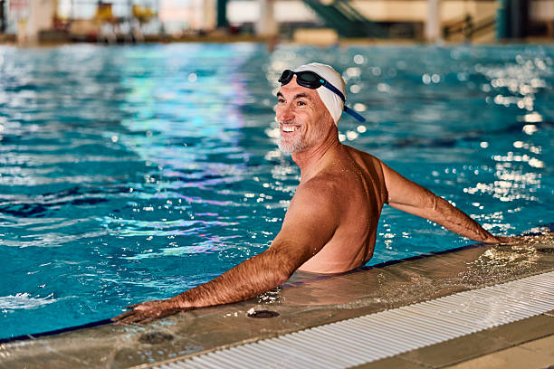 istock Happy senior man enjoying an active swim in pool 2252059458