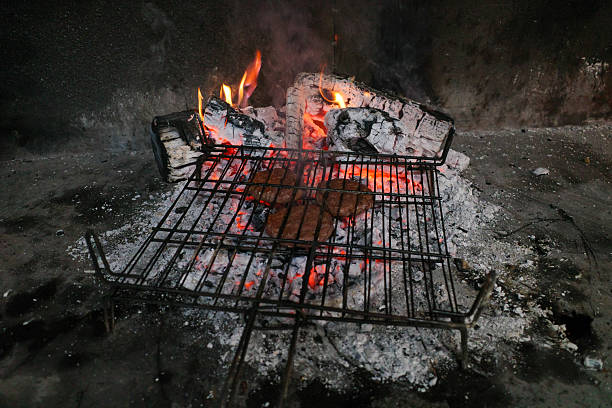 The rib steaks (cote de boeuf) being grilled on an open fire