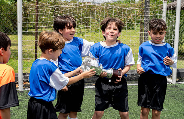 istock Happy soccer team winning a trophy and celebrating 2252061838