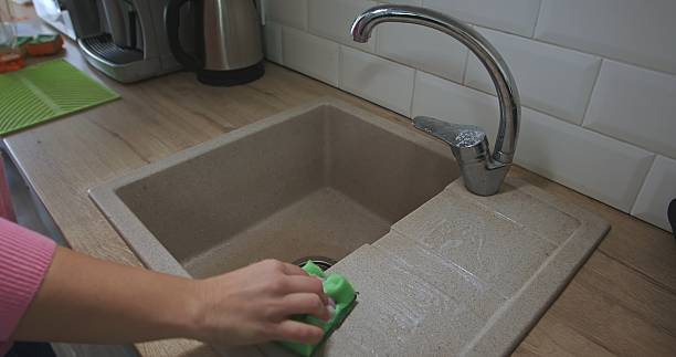 istock Hand Cleaning Kitchen Sink with Green Sponge 2252062323