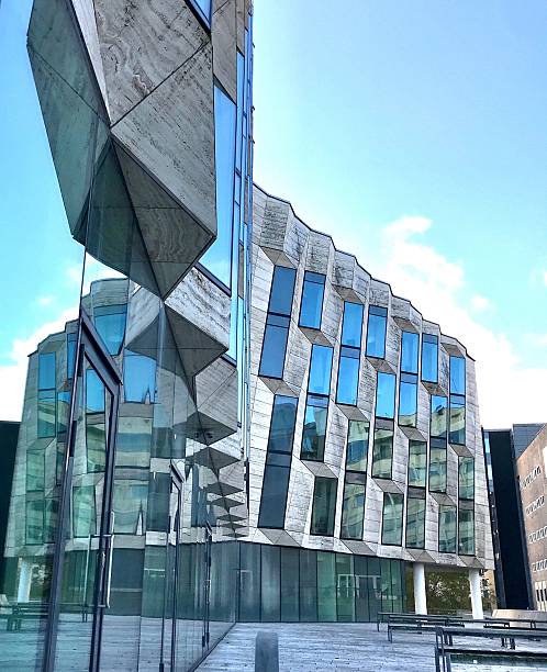 istock Modern office building with glass facade that reflects itself 2252063675