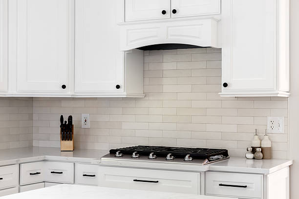 istock A stovetop and range hood detail in a white kitchen. 2252066307