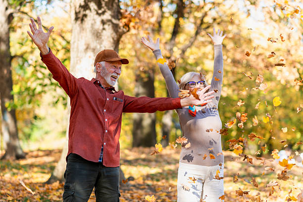 istock Senior couple throwing autumn leaves 2252066404