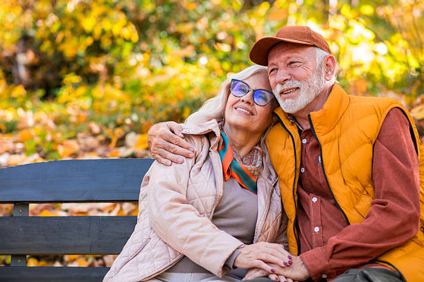 istock Senior couple relaxing on park bench 2252066619