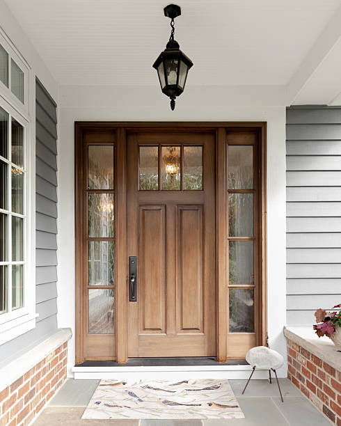 istock A wooden front door on a grey and white home. 2252067522