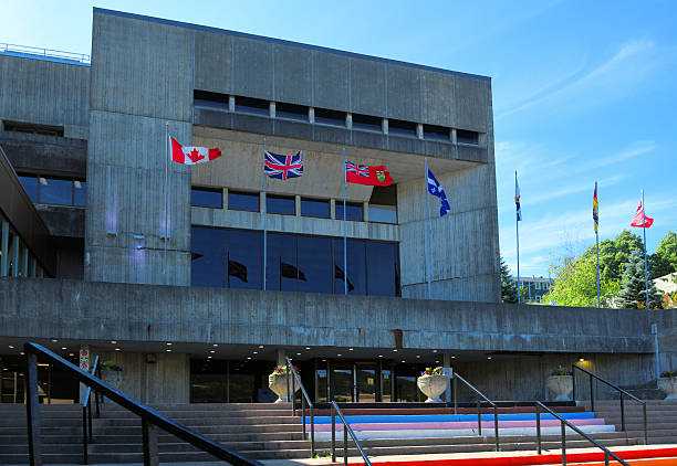 St. John's, Newfoundland, Canada: St. John's City Hall, the seat of municipal government for the capital city of Newfoundland and Labrador. Opened in 1970, the building is a prominent example of Brutalist architecture, characterized by its stark, angular concrete façade and heavy massing. Located on New Gower Street, the structure anchors the civic center of North America's oldest English-founded city.