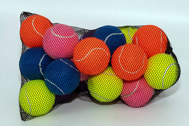A mesh bag full of multi-coloured tennis balls in Sydney, NSW, Australia. (Photo by Tara Chand Malhotra)