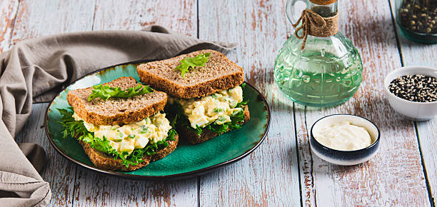 istock Savory egg salad sandwich with avocado on whole grain bread on a plate web banner 2252072641