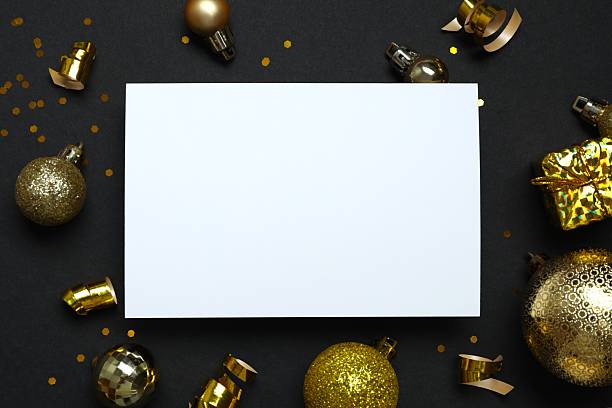 istock White paper card and Christmas decorations on black background 2252073158