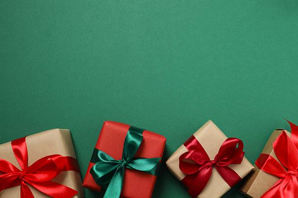 istock Beautiful Christmas gift boxes on color background 2252073248