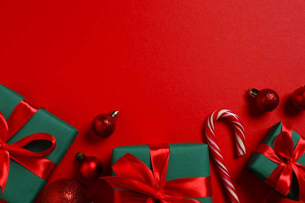 istock Beautiful gift boxes tied with bows and Christmas decorations on color background 2252073786