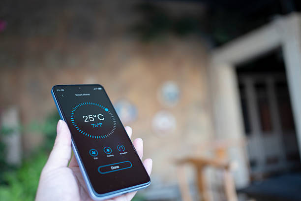 istock Using smart home with handheld mobile phones at home 2252075666