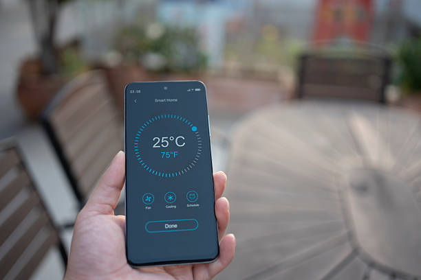 istock Using smart home with handheld mobile phones at home 2252075688