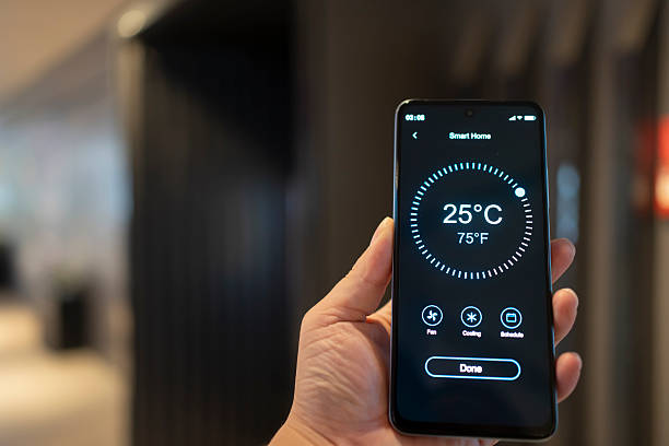 istock Using smart home with handheld mobile phones at home 2252075707