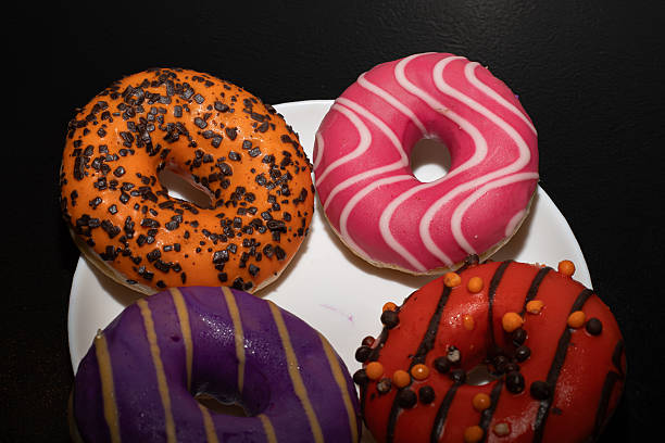 istock Multicolored donuts of various varieties on a black background. Pastry. 2252078499