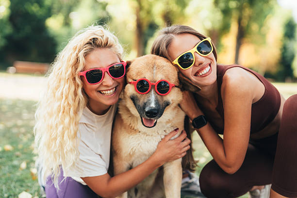 istock Best friends having fun with their cool dog 2252078741