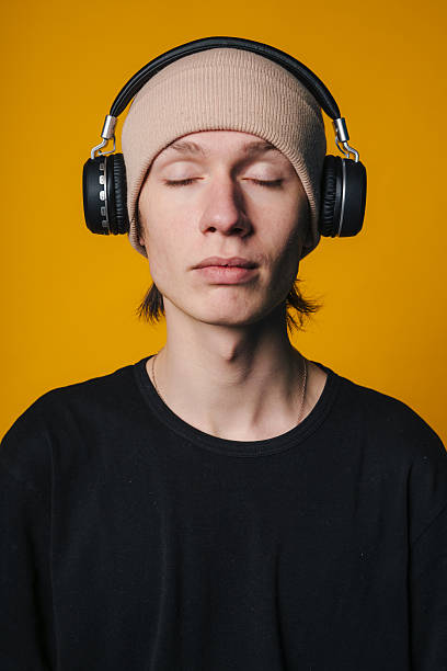 Beautiful woman listening music with headphone outdoor in the city