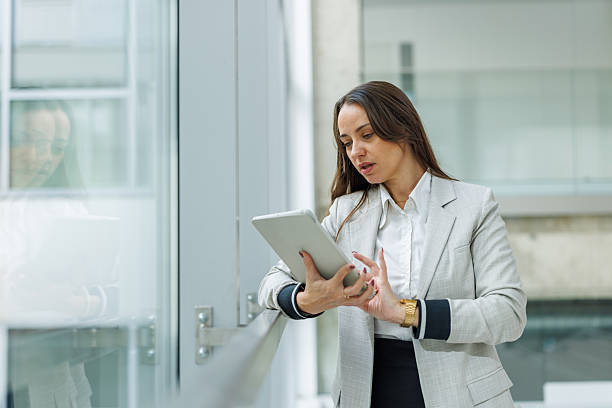 istock Businesswoman using tablet in modern office environment 2252080956