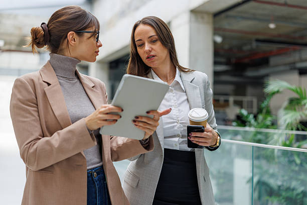 istock Businesswomen discussing data on tablet during office meeting 2252081030