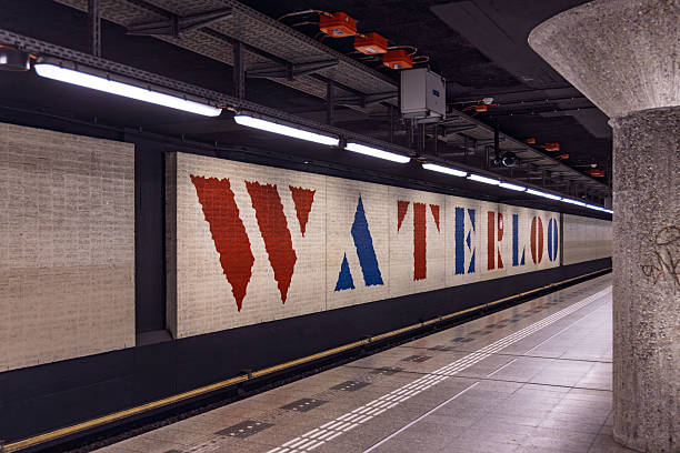 Long shot of the platform and subway wall at Waterlooplein metro station, Amsterdam, featuring the iconic WATERLOO artwork in red and blue.