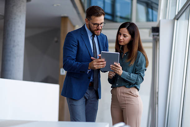 istock Colleagues in a bright office, collaborating on business tactics and reviewing data using a digital tablet during a meeting 2252081340