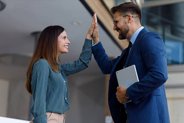 istock Business colleagues celebrating a successful partnership with a high five, showing teamwork and collaboration between professionals 2252081571