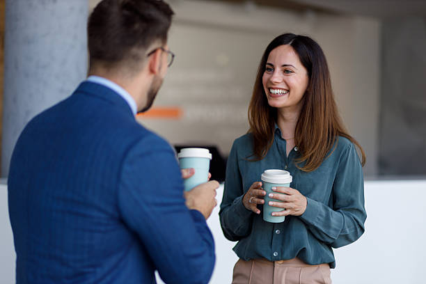 istock Two cheerful business colleagues enjoying a coffee break, smiling and having a conversation, sharing ideas and networking 2252081674