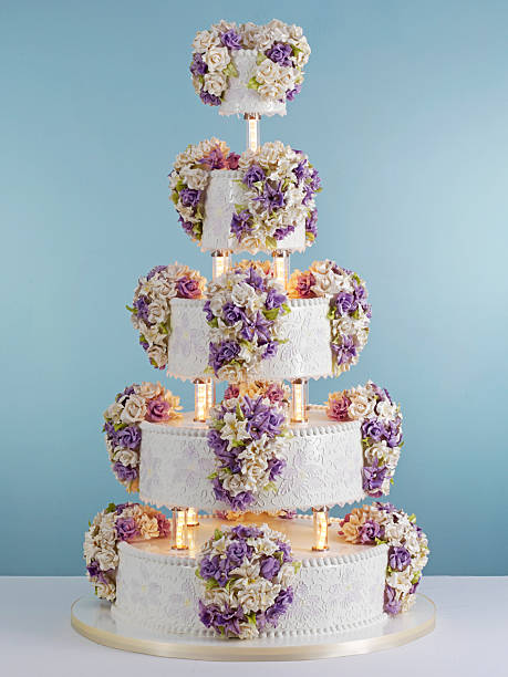 istock Tall multi tier wedding cake decorated with flowers in pastel place setting.​ 2252082474