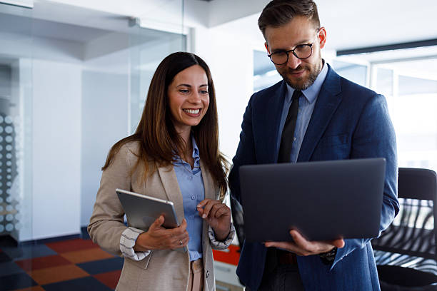 istock Business colleagues collaborating on laptop and discussing project in modern office environment 2252082985
