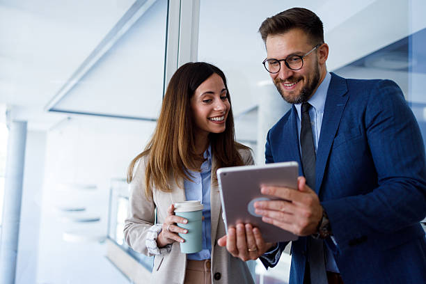 istock Business professionals having informal meeting in office while using digital tablet and drinking coffee 2252083034