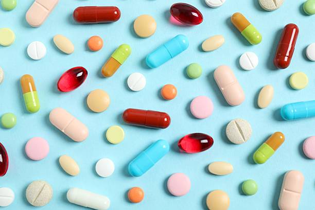 istock Various medical pills on blue background 2252084251