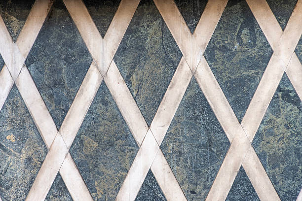 Geometric stone pattern of rhombuses as a decorative texture for floors or walls.