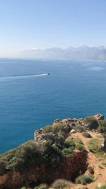 istock Serene Mediterranean landscape featuring a tranquil sea, rocky cliffs, and distant mountains, evoking a sense of peace and natural beauty 2252085768
