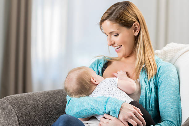 istock Happy mother lovingly breastfeeding her infant child in a comfortable home setting 2252086060