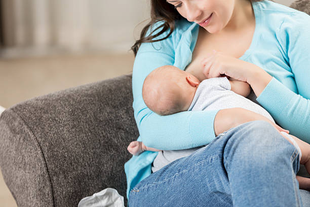 istock Mother gently breastfeeding her baby in a comfortable indoor setting with a focus on their bond. 2252086077