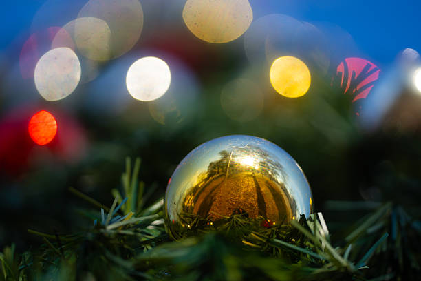 Christmas tree background in bright bokeh. Shiny baubles with bokeh. Decorations Christmas. Colorful baubles with festive bokeh