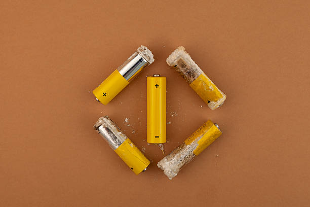 istock Oxidized and leaked AA alkaline batteries. White powder Potassium hydroxide was formed by leakage of alkaline electrolyte. Hydroxides and carbonates are dangerous, powder caustic 2252086596