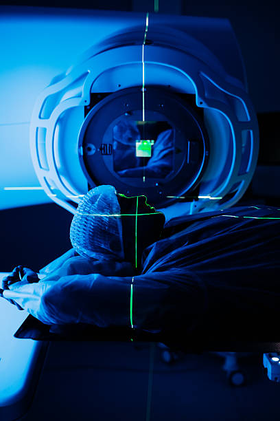 istock Linear accelerator in oncology treatment room, patient positioned for therapy 2252089329