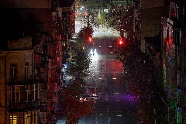 istock Dark street with car headlights at night 2252089531