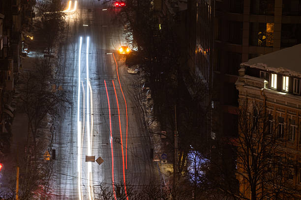 istock Snowy winter street with traffic light trails 2252089572