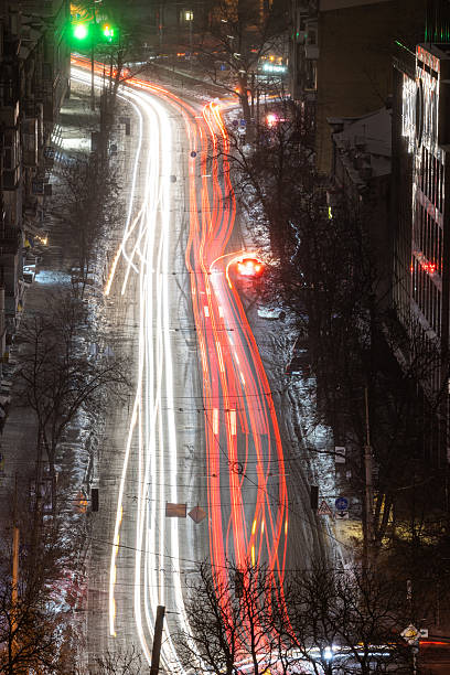 istock Snowy urban avenue with red light trails 2252089595