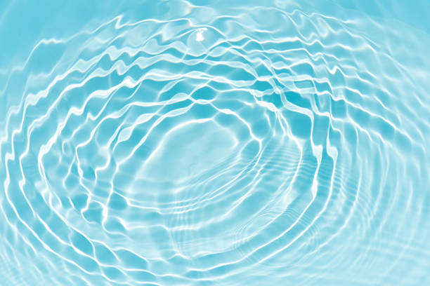 istock Bluewater waves on the surface ripples blurred. Defocus blurred transparent blue colored clear calm water surface texture with splash and bubbles. Water waves with shining pattern texture background. 2252090641