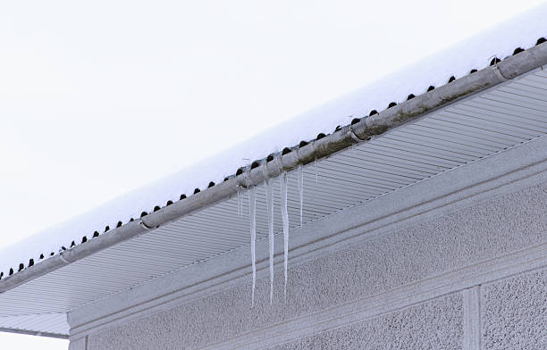 istock Icicles hanging from a roof edge in a snowy environment 2252091690