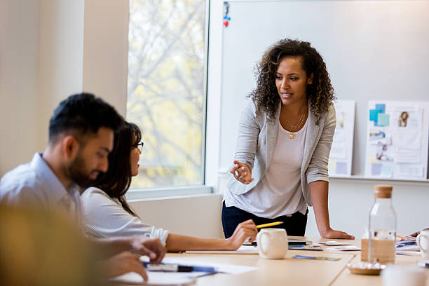 istock Diverse group in a professional meeting collaborating around a table with presentation boards. 2252093082