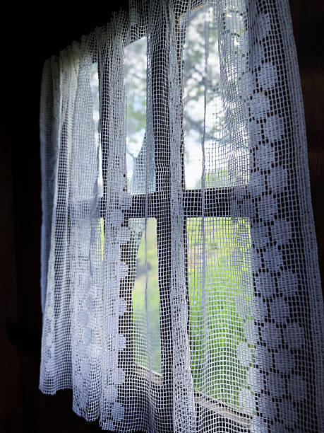 istock Rustic home window with handmade lace curtain 2252093093