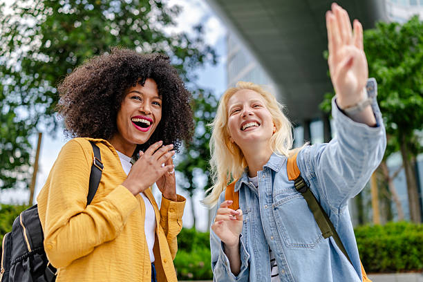 istock Two young women enjoy a sunny day outdoors while sharing smiles and laughter in a diverse friendship 2252096141