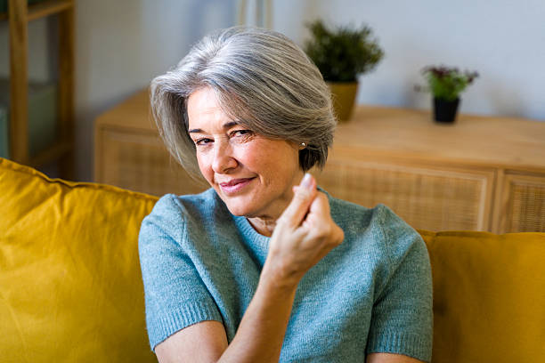 istock Senior woman making hand gesture expressing money 2252096463