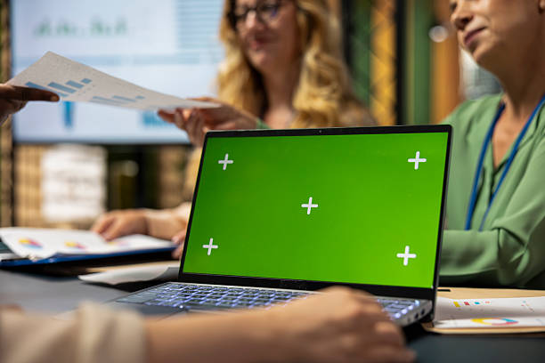 istock Group of business partners reviewing project analytics with green screen 2252097344